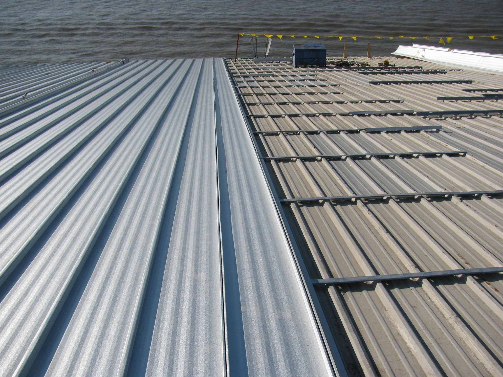 Commercial roof crew installing a low-slope roof system